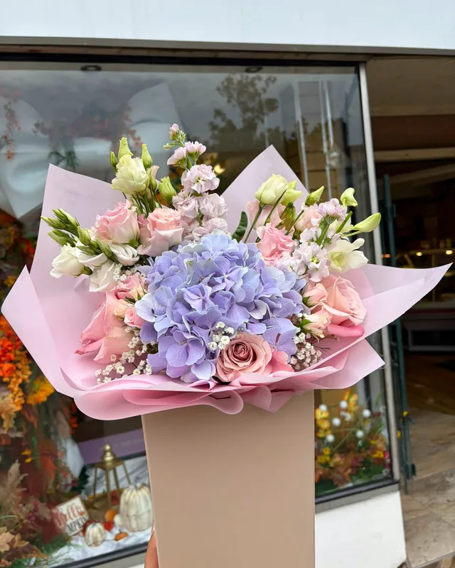 Pastel hand tied bouquet with hydrangea and roses